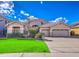 Charming home featuring a well-manicured lawn, desert landscaping and a three-car garage at 1086 S Western Skies Dr, Gilbert, AZ 85296