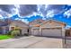 Spacious three-car garage and driveway of a charming single Gathering home in a suburban neighborhood at 1086 S Western Skies Dr, Gilbert, AZ 85296