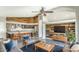 Open-concept living room featuring a wood accent wall, fireplace, and kitchen view at 1086 S Western Skies Dr, Gilbert, AZ 85296