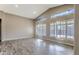 Spacious living room with vaulted ceilings, shutters, and modern wood-look tile flooring at 1086 S Western Skies Dr, Gilbert, AZ 85296