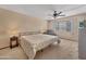 This bedroom features neutral walls, carpet, and a ceiling fan at 10906 W Thunderbird Blvd, Sun City, AZ 85351