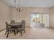 Dining room features a modern chandelier and a sliding door to the outside patio at 10906 W Thunderbird Blvd, Sun City, AZ 85351