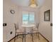 Cozy kitchen nook with a small table, two chairs, and window overlooking the exterior at 10906 W Thunderbird Blvd, Sun City, AZ 85351