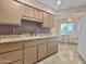 Functional kitchen with a dining table near the sink and the white appliances at 10906 W Thunderbird Blvd, Sun City, AZ 85351