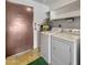 A laundry room featuring a washer and dryer with overhead shelving at 10906 W Thunderbird Blvd, Sun City, AZ 85351