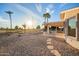 Backyard featuring desert landscaping with a covered patio and views of the golf course at 11005 W Crestbrook Dr, Sun City, AZ 85351