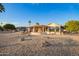 Backyard featuring desert landscaping and a spacious covered patio perfect for outdoor entertaining at 11005 W Crestbrook Dr, Sun City, AZ 85351