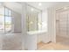 Bathroom vanity area with marble floors and open layout to bedroom and closet at 11005 W Crestbrook Dr, Sun City, AZ 85351