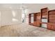 Bright bedroom with custom-built wooden shelving, ceiling fan and an expansive window for natural light at 11005 W Crestbrook Dr, Sun City, AZ 85351