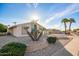 Charming single-story home with gravel landscaping, unique desert plants, and a lush green bush at 11005 W Crestbrook Dr, Sun City, AZ 85351