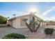 Charming single-story home with gravel landscaping, unique desert plants, and a lush green bush at 11005 W Crestbrook Dr, Sun City, AZ 85351