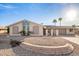 Charming single-story home with a low-maintenance gravel yard, desert landscaping, and palm trees at 11005 W Crestbrook Dr, Sun City, AZ 85351