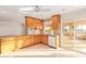 Bright kitchen features light wood cabinets, granite countertops, and sliding doors to the outside patio at 11005 W Crestbrook Dr, Sun City, AZ 85351