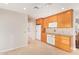 Bright kitchen with tile floors features wood cabinetry, tile countertops and white appliances at 11005 W Crestbrook Dr, Sun City, AZ 85351