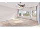 Inviting main bedroom featuring carpeting, vaulted ceiling, and large windows at 11005 W Crestbrook Dr, Sun City, AZ 85351