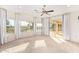 Bright main bedroom featuring vaulted ceiling, carpet, and large windows with great views at 11005 W Crestbrook Dr, Sun City, AZ 85351