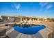 Backyard view featuring pool, covered patio, and desert landscaping at 11005 W Crestbrook Dr, Sun City, AZ 85351