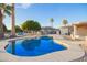 Backyard pool with mature landscaping, and wrought iron fence at 11005 W Crestbrook Dr, Sun City, AZ 85351