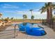 A kidney-shaped pool with a lush golf course in the background at 11005 W Crestbrook Dr, Sun City, AZ 85351