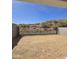 Ready-to-landscape backyard featuring desert views and secured with a metal view fence at 1111 E Mcneil St, Phoenix, AZ 85042