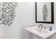 Stylish powder room with modern wall art and a pedestal sink at 1111 E Mcneil St, Phoenix, AZ 85042