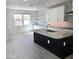 Modern kitchen with black island, stainless steel appliances, and bright white cabinets at 1111 E Mcneil St, Phoenix, AZ 85042