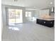 Bright, open-concept living room with tile floors and sliding glass doors to the backyard at 1111 E Mcneil St, Phoenix, AZ 85042