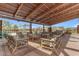 Inviting outdoor common area under a beamed pergola featuring comfortable lounge furniture and desert landscaping at 1111 E Mcneil St, Phoenix, AZ 85044