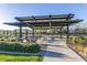 Community pergola with modern design over outdoor seating area, offering shade and a place to relax at 1111 E Mcneil St, Phoenix, AZ 85044