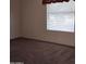 Bedroom featuring neutral carpet, a window with blinds, and a blank canvas at 11411 N 91St Ave # 122, Peoria, AZ 85345