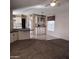 A well-lit living room with a ceiling fan opens to the kitchen, featuring white cabinetry and a breakfast bar at 11411 N 91St Ave # 122, Peoria, AZ 85345