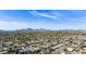 Panoramic aerial view featuring a residential neighborhood with mountain views, mature trees, and clear blue sky at 12836 N 60Th St, Scottsdale, AZ 85254