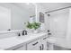 Bathroom featuring a large sink with matte black fixtures, white cabinets, and a plant at 13238 W Market St, Surprise, AZ 85374