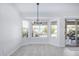 Bright dining room with a view of the well-maintained backyard and contemporary light fixture at 13238 W Market St, Surprise, AZ 85374