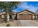 Charming single-story home showcasing a neutral color palette, attached garage, and low maintenance landscaping at 13238 W Market St, Surprise, AZ 85374