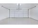 Clean garage with white epoxy floors and a white garage door at 13238 W Market St, Surprise, AZ 85374