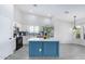 Modern kitchen showcasing white cabinetry, subway tile backsplash, and a blue island with quartz countertop at 13238 W Market St, Surprise, AZ 85374