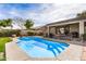 Backyard pool area with a lounge chairs, manicured landscaping, and an adjacent covered patio at 13238 W Market St, Surprise, AZ 85374