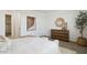 Well-lit bedroom featuring a modern dresser and decorative wall art at 1350 W Kennedy Ave, Coolidge, AZ 85128