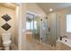 Bathroom featuring a glass enclosed shower, a bathtub and decorative wall art at 1363 E Amberwood Dr, Phoenix, AZ 85048