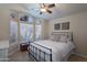 Comfortable bedroom featuring a ceiling fan, a bay window, and tile floors at 1363 E Amberwood Dr, Phoenix, AZ 85048