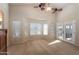 Bright bedroom featuring a ceiling fan, a bay window and a glass door leading outside at 1363 E Amberwood Dr, Phoenix, AZ 85048