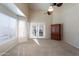 Bright bedroom featuring a ceiling fan, a bay window and double doors leading outside at 1363 E Amberwood Dr, Phoenix, AZ 85048