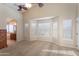 Bright bedroom featuring a ceiling fan, a bay window and a partial bathroom view at 1363 E Amberwood Dr, Phoenix, AZ 85048