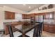 Beautiful kitchen featuring dark cabinetry, granite counters, stainless appliances, and island with seating at 1363 E Amberwood Dr, Phoenix, AZ 85048