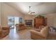 Spacious living room featuring tile flooring, stone fireplace, and plenty of seating at 1363 E Amberwood Dr, Phoenix, AZ 85048