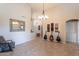 Bright and airy living room with a decorative mirror and three guitars on display at 1363 E Amberwood Dr, Phoenix, AZ 85048