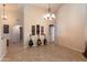 Spacious Living room featuring tile flooring, stylish lighting, and neutral wall color at 1363 E Amberwood Dr, Phoenix, AZ 85048