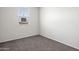 Carpeted bedroom with a window that provides a view of the neighborhood at 1372 W Hess Ave, Coolidge, AZ 85128