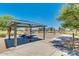 Community playground featuring a shaded picnic area, swings, slides, and climbing structures for Gathering enjoyment at 1372 W Hess Ave, Coolidge, AZ 85128